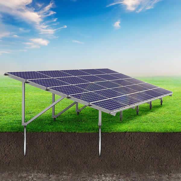 Ground-mounted solar panel array on metal racking system in grassy field under blue sky