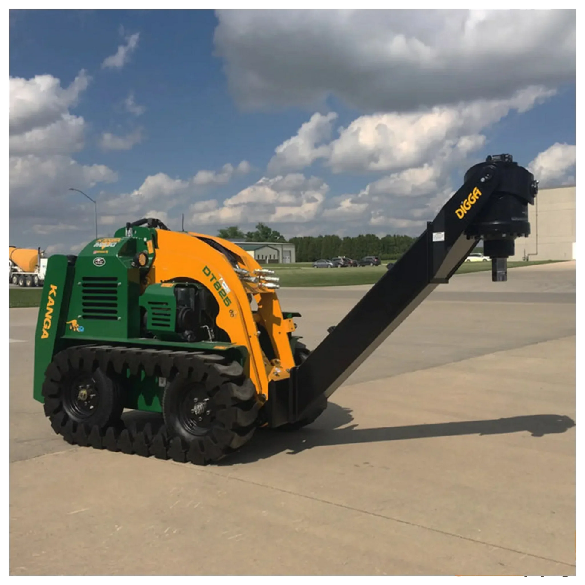 Green and yellow KANGA mini skid steer with black DIGGA auger attachment on concrete under cloudy sky