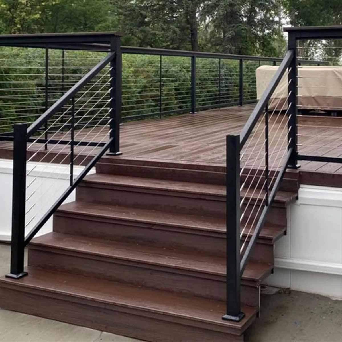 Modern deck stairs with black metal railings and cable balusters, outdoor wooden staircase design