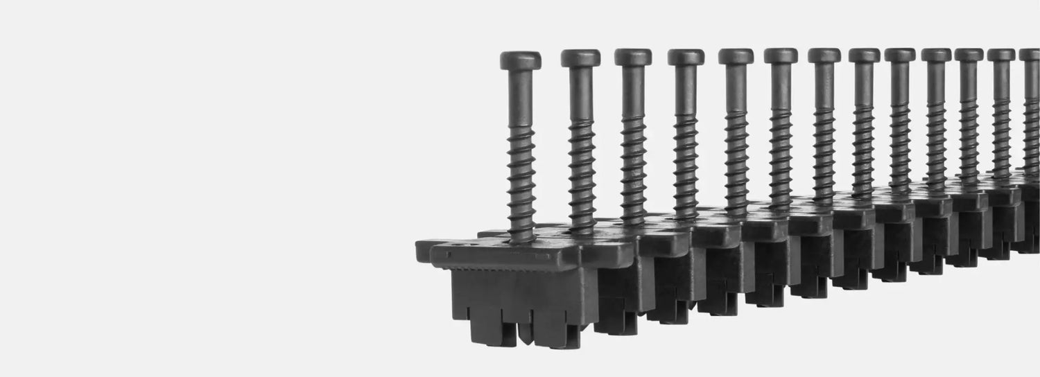 Black industrial screws in plastic strip for manufacturing and assembly applications